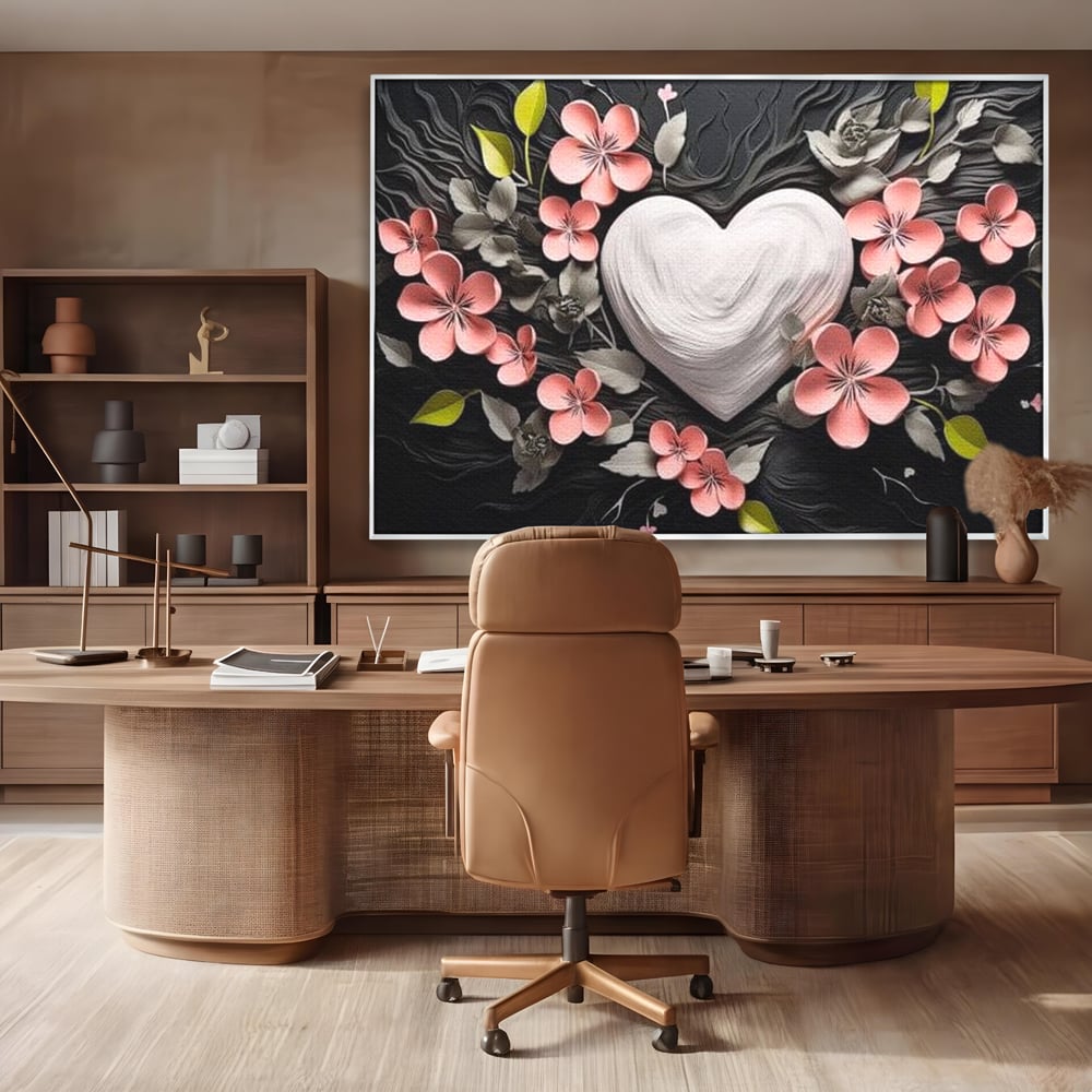 Tablou canvas cu tablou canvas cu inima alba si flori roz, in rama de aluminiu argintiu, pe perete intr-un birou